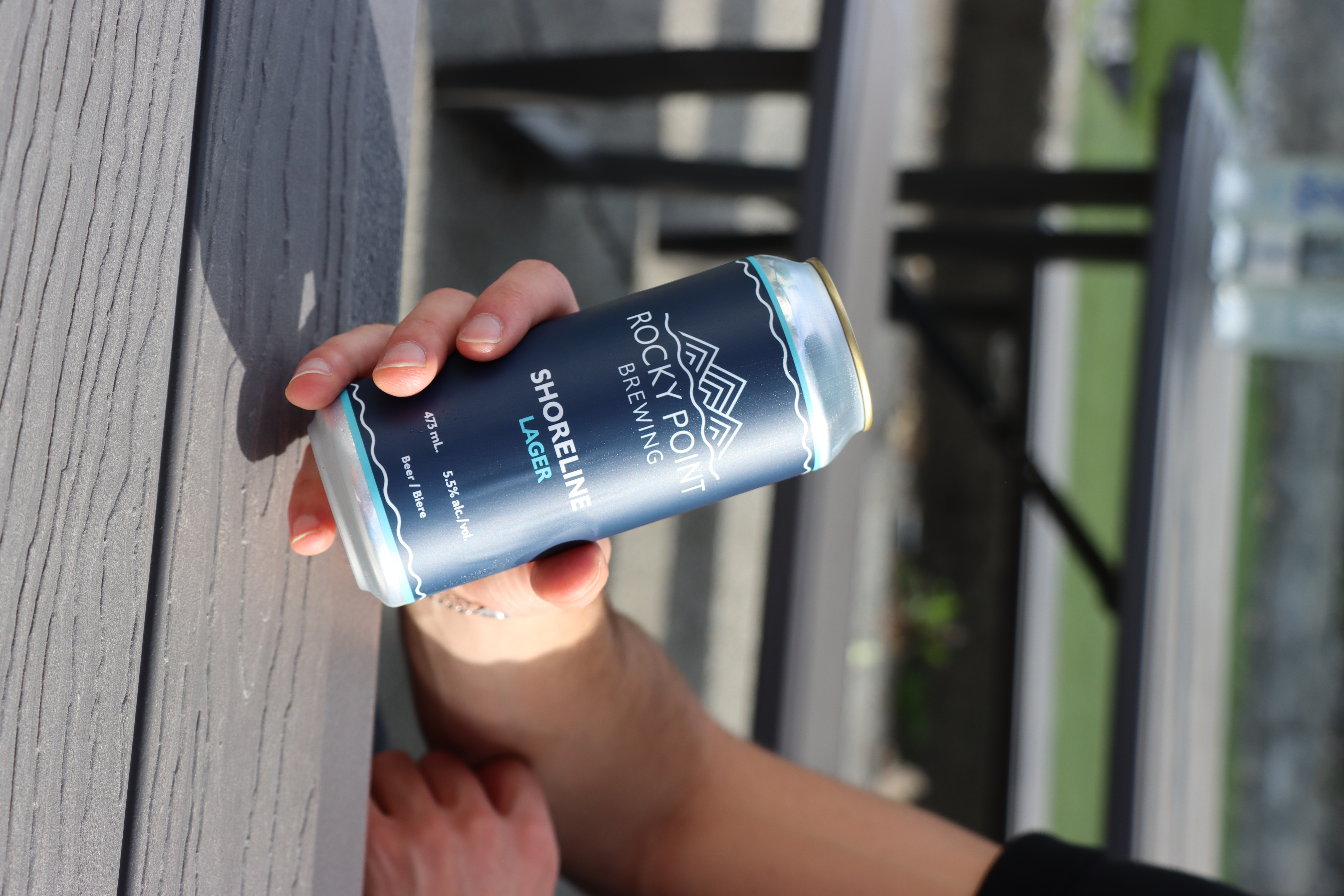 Guest holding Rocky Point beer can